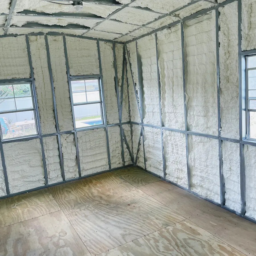 Closed-cell spray foam insulation applied to wall cavities in a residential project in Troy
